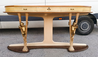 Consolle in pergamena e legno con  putti dorati e piano in vetro firmata Associazione Artigiani Canturini  Italia 1950