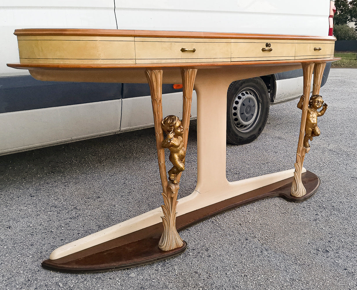 Consolle in pergamena e legno con  putti dorati e piano in vetro firmata Associazione Artigiani Canturini  Italia 1950
