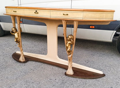 Consolle in pergamena e legno con  putti dorati e piano in vetro firmata Associazione Artigiani Canturini  Italia 1950