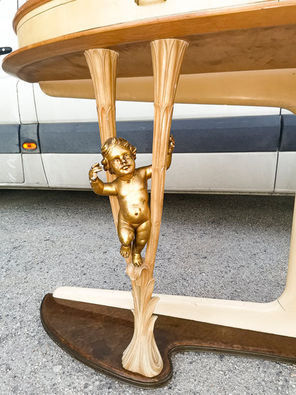 Consolle in pergamena e legno con  putti dorati e piano in vetro firmata Associazione Artigiani Canturini  Italia 1950