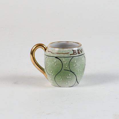 tazza decorata verde con borso oro scritta bevi amore