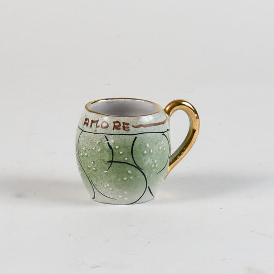 tazza decorata verde con borso oro scritta bevi amore