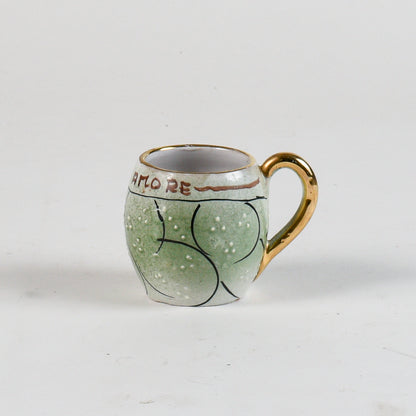 tazza decorata verde con borso oro scritta bevi amore