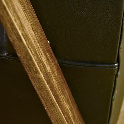 Poltrona verde scuro in pelle e legno di Anonima Castelli anni 40