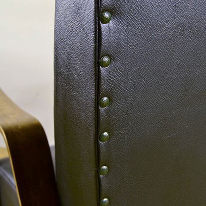Poltrona verde scuro in pelle e legno di Anonima Castelli anni 40